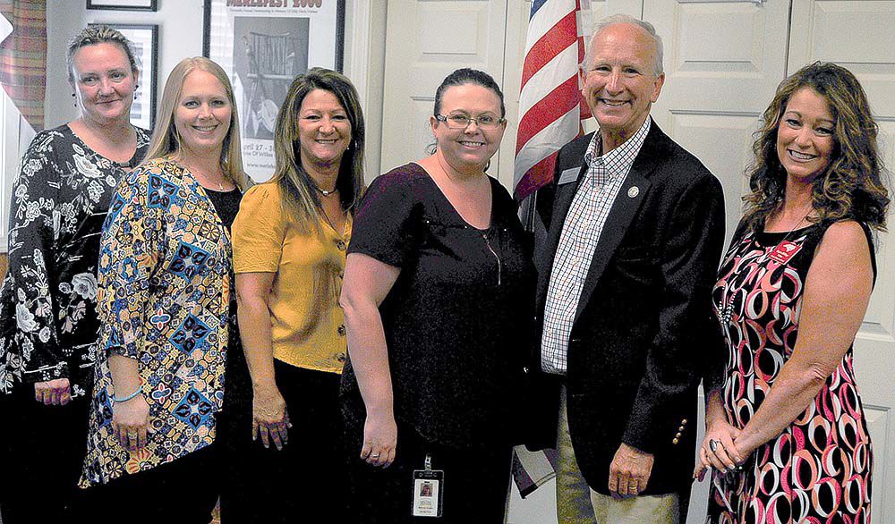 Newby with clerk staff